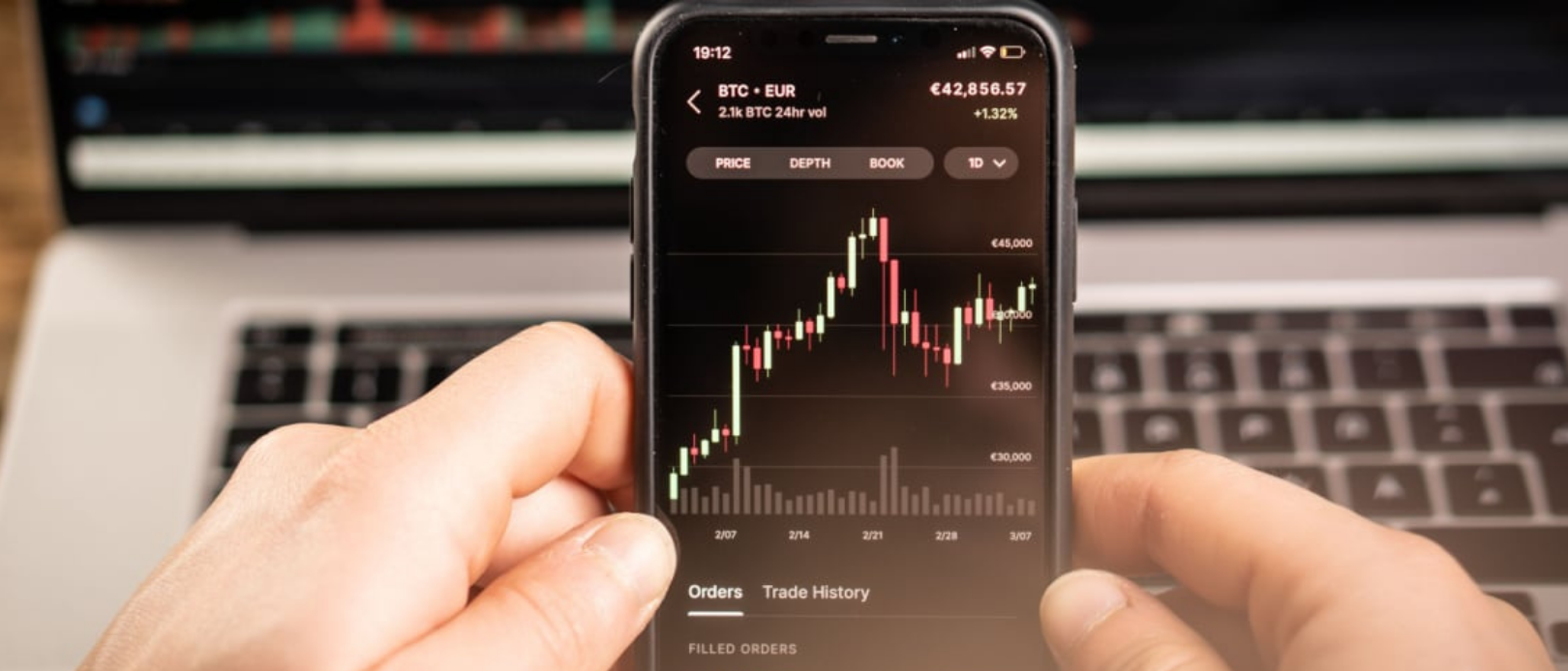 LIPTOVSKY MIKULAS, SLOVAKIA MARCH 9, 2021: A man holds a phone in his hand and trades in cryptocurrencies on the stock exchange.